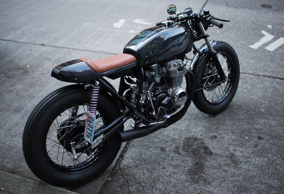 Retro-style motorcycle parked on an urban street, showcasing a classic design.