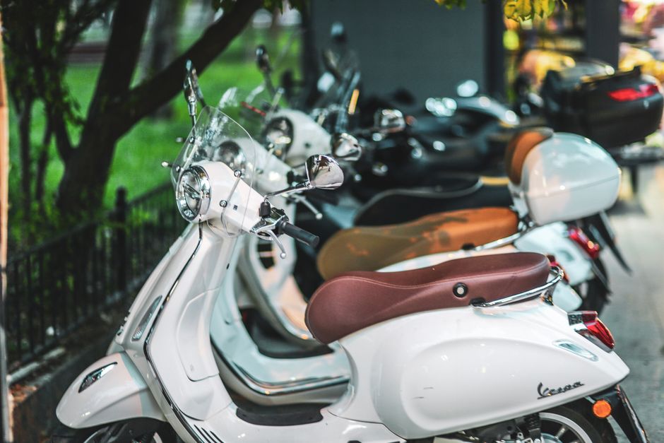 Row of parked Vespas on a vibrant street in Istanbul, evoking travel and adventure.